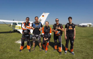 01-millennium-tandem-team-group-dropzone Millennium Tandem Team at the drop zone before tandem skydiving