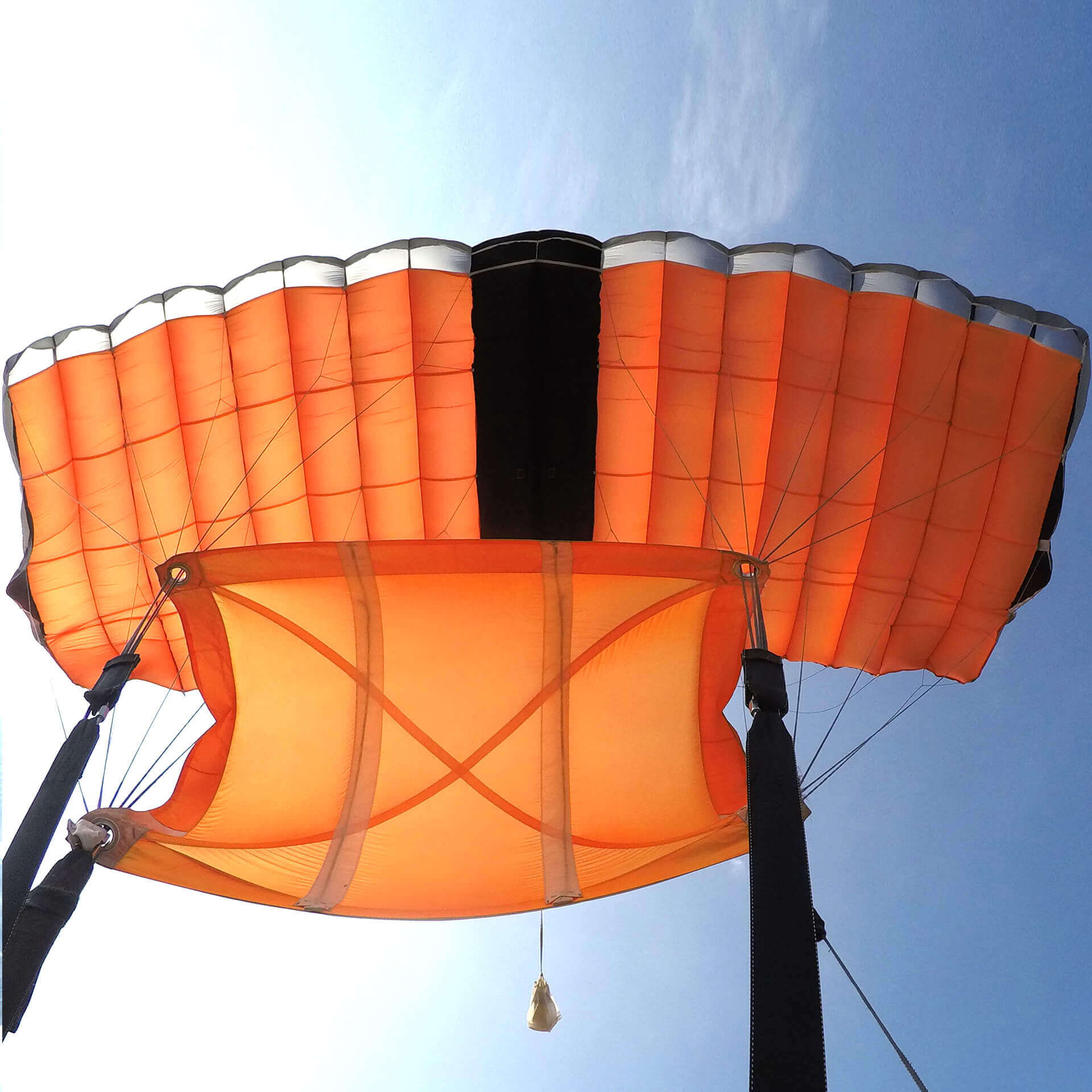 tandem-skydiving-faq-parachute-canopy-hero-m Tandem skydiving FAQ image showing an open parachute canopy during descent